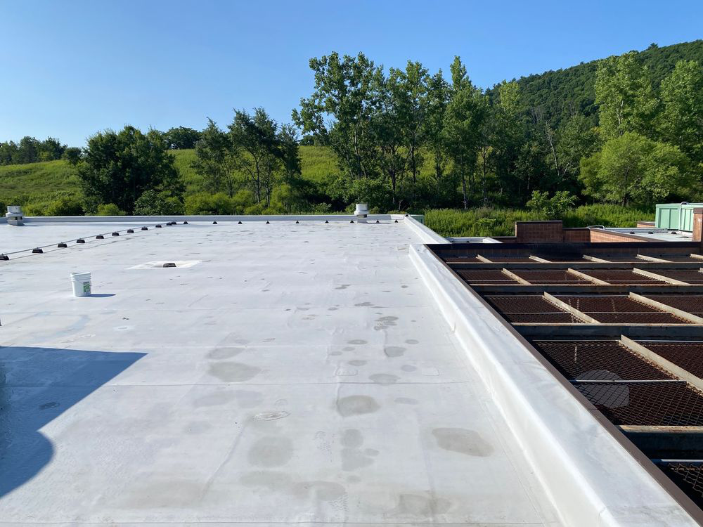Low-slope commercial roof with rooftop equipment